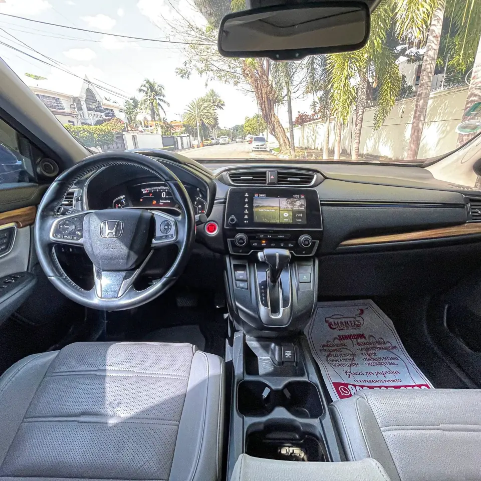 Honda steering wheel, dashboard and front seats viewed inside the CR-V